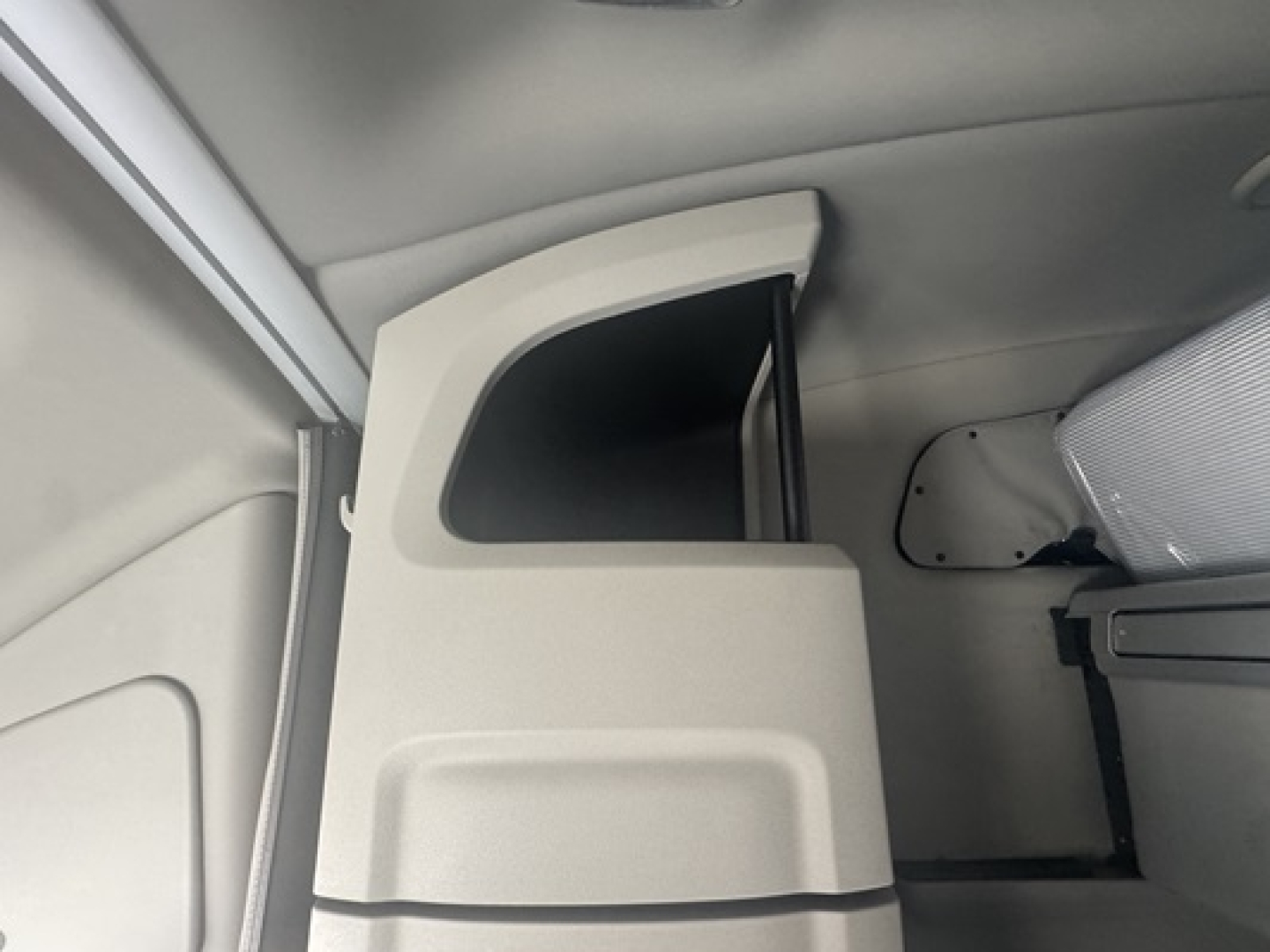 Cab interior of a Peterbilt 579 truck showing a light gray door panel, window frame, and sleeper area; no specific labels visible.