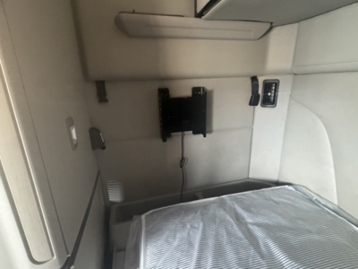 Peterbilt 579 cab interior showing sleeper area with mounting bracket and power outlet, view from passenger side.