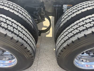 Peterbilt 579 truck chassis view showing dual rear axles with tires and suspension components.