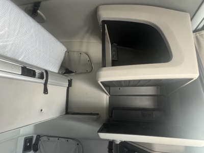 Peterbilt 579 sleeper cab interior showing storage compartments and a small open shelf with lid.