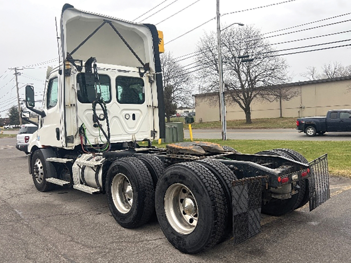 Truck chassis and cab 2021 Freightliner Cascadia126 in service showing rear chassis and dual rear axles.