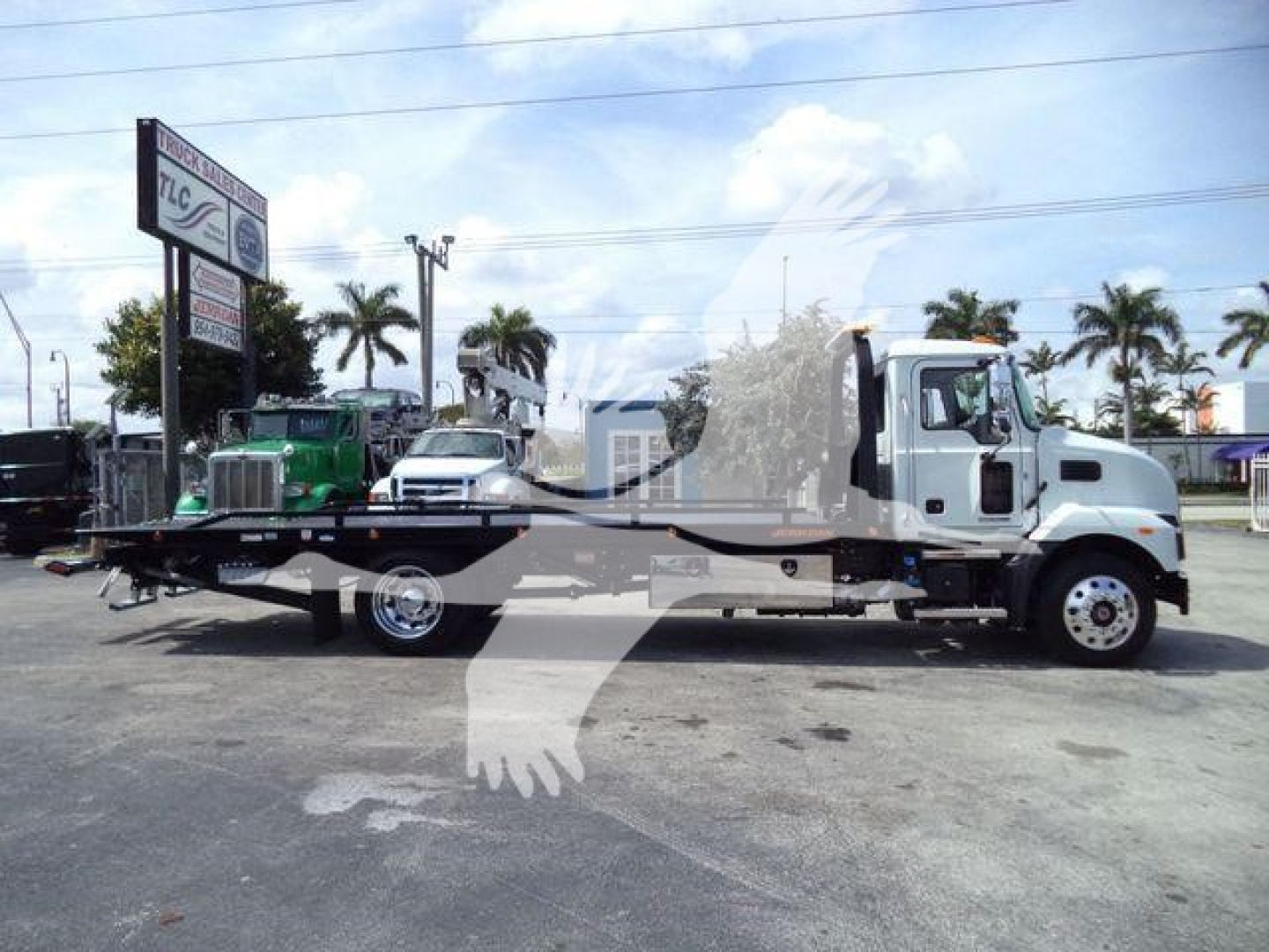 MD6 tow truck side view with flatbed, Mack badge visible, stock number J13303, rollback category, new truck.
