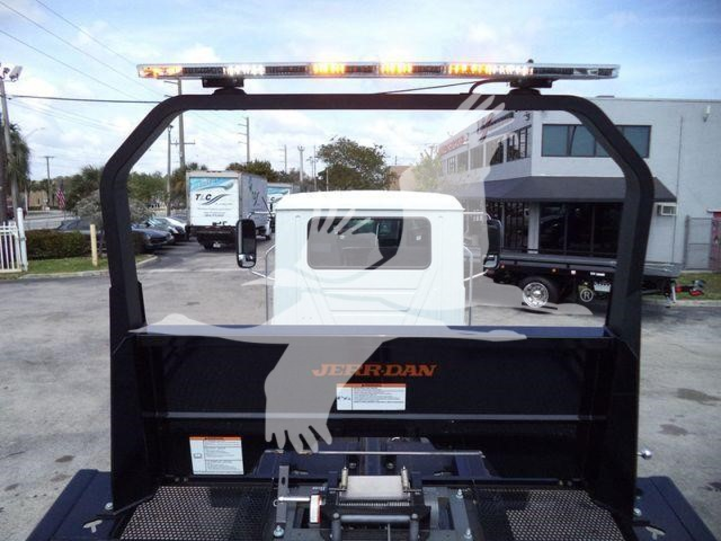 Trucks equipment bay showing Jerr-Dan MDT MD6 rollback body with top light bar and mounting arch.