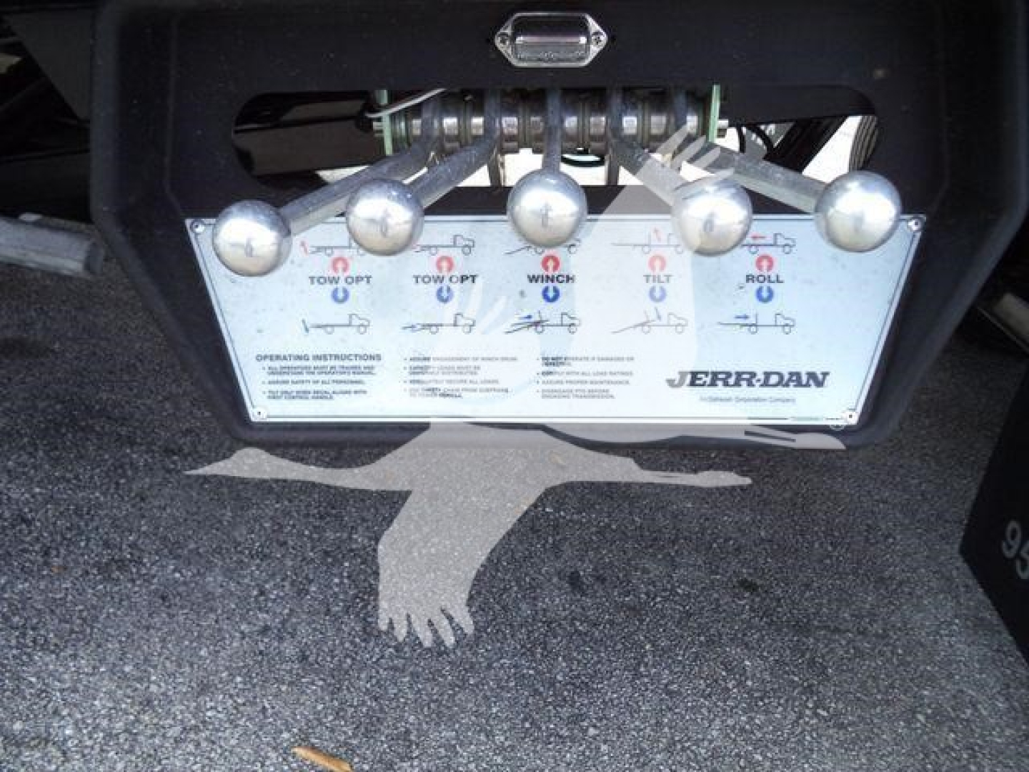 Dashboard-style control panel with multiple levers and a label showing JERR-DAN towing controls for a Mack MD6 rollback truck.