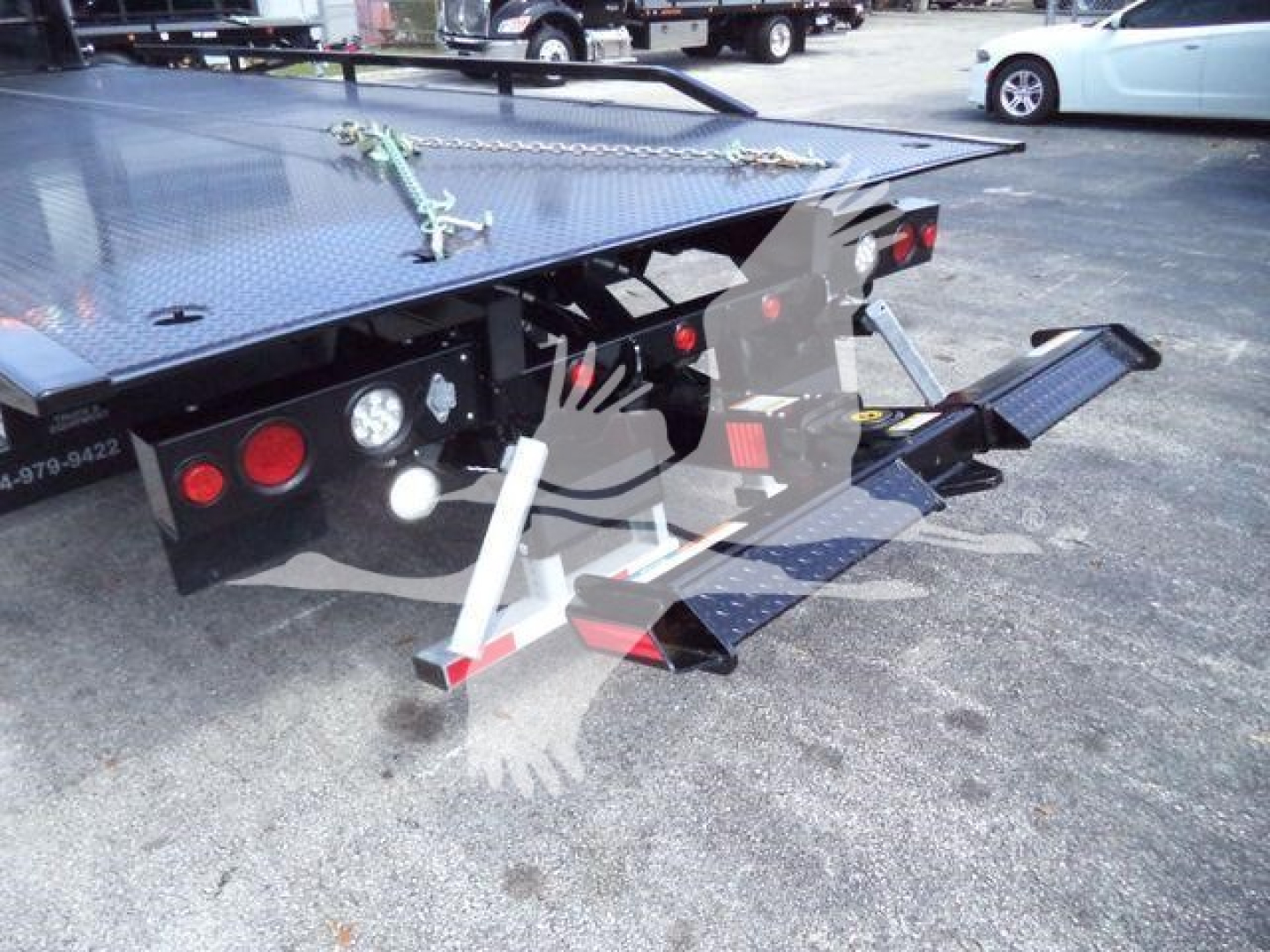 MD6 rollback truck rear view showing loading ramps and flatbed with diamond plate surface.