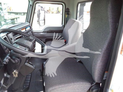Truck cab interior showing steering wheel, dashboard, and driver seat of a 2027 Mack MD6 rollback truck.