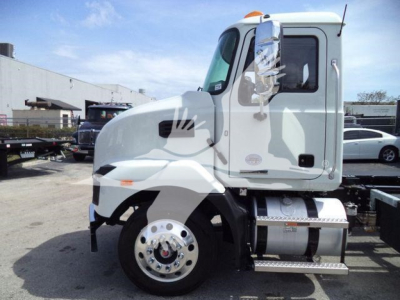 MD6 truck side view showing cab and fuel tanks with chrome wheels and diamond plate steps
