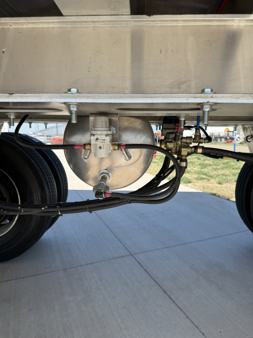 Hicks FL2827 spread axle trailer undercarriage showing brake chamber, air lines, and wiring with metallic frame.