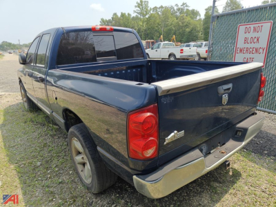 Dodge Ram 1500 Crew Cab pickup truck rear view with bed cap open, dark blue paint, tailgate and rear bumper visible.