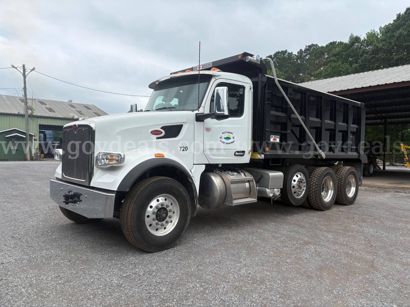 Peterbilt 377 dump truck in-service showing white cab and black dump body with dual rear axles. VIN and stock number not visible on body.