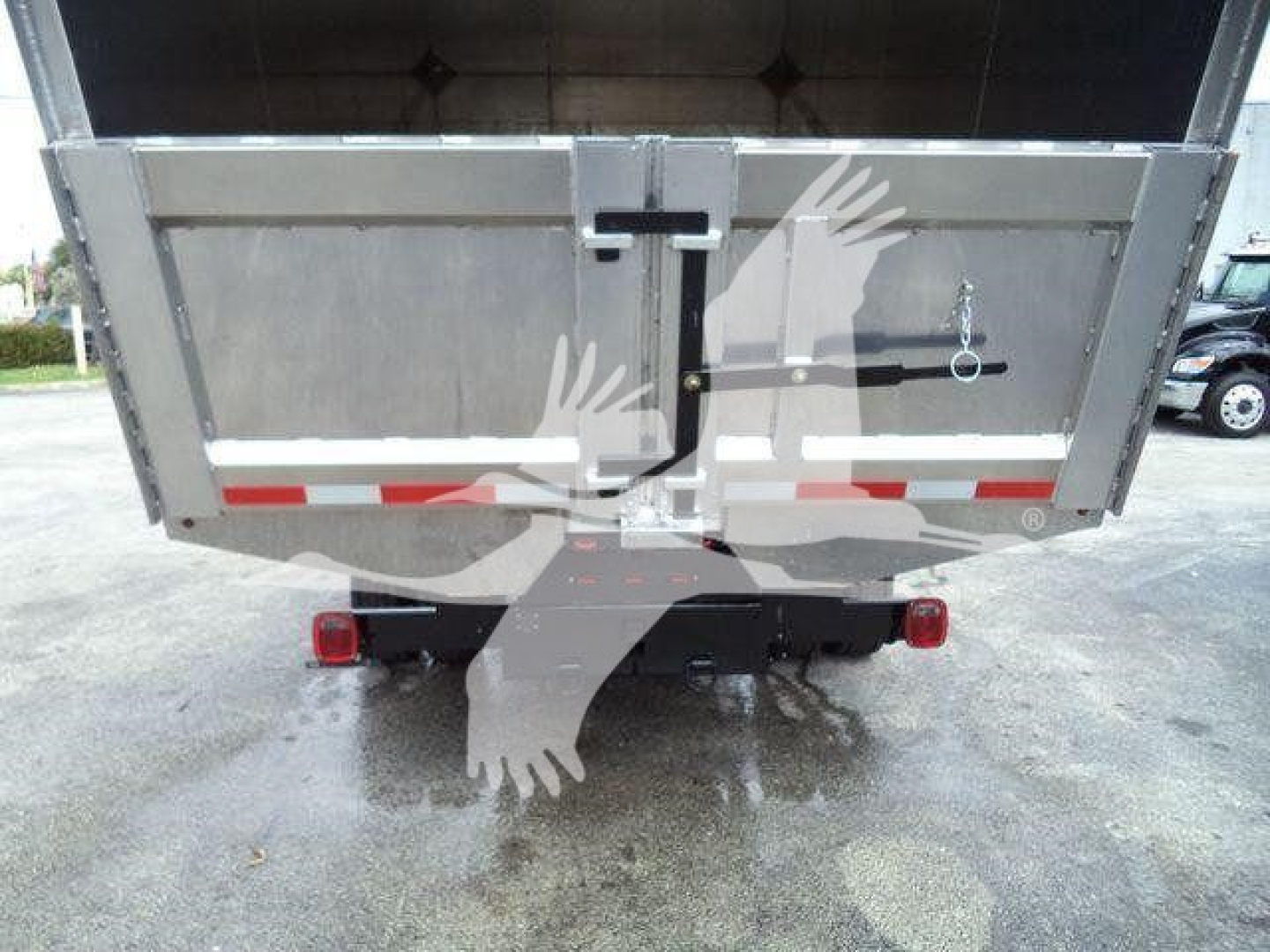 Truck rear view of a 2023 Chevrolet Silverado 6500Hd dump/box showing taillights, rear bumper, and hydraulic tilt. Stock T05573FM, chipper category, used.