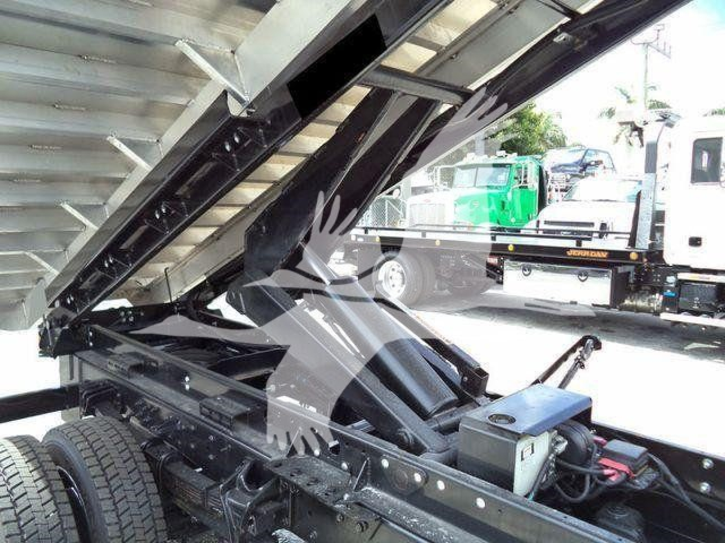 Truck chassis and hydraulic lifting mechanism of a Silverado 6500HD chassis showing metal frame and hydraulic components.