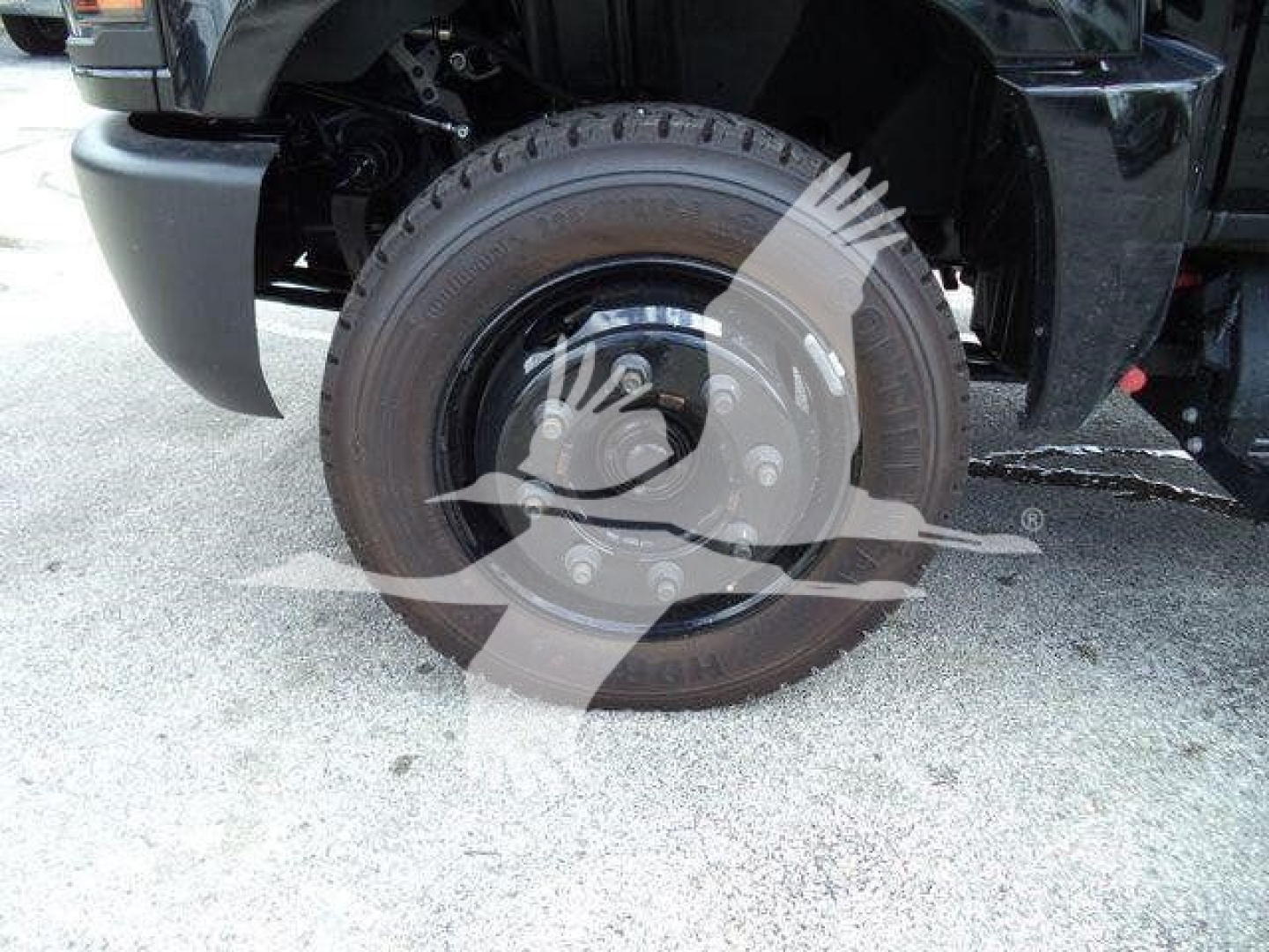 Truck wheel and fender area of a 2023 Chevrolet Silverado 6500Hd with visible tire and wheel hub.