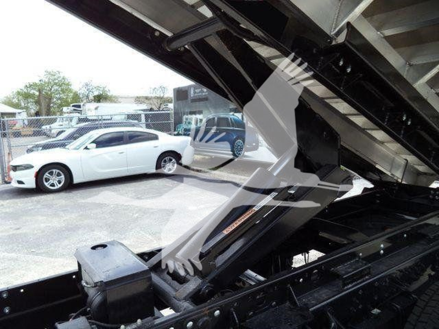 Chevy Silverado 6500HD body and chipper truck bed interior showing hydraulic components and controls.