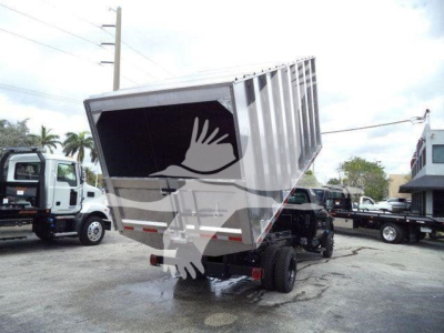 Dump-bed truck with Chevrolet Silverado 6500HD chassis and dump body, rear view showing large dump bed tilted upward.