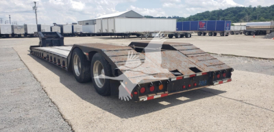 Load King beavertail lowboy trailer with tandem axles and ramp, rear view showing taillights and reflective markings.
