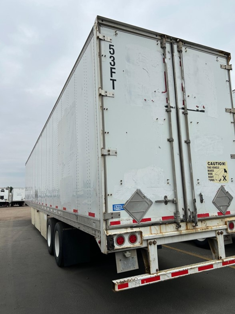 Trailer rear view of a 2014 Stoughton Air Ride Dry Van showing doors, taillights, and bumper with warning stickers.