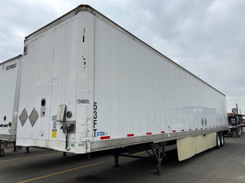 Stoughton air-ride dry van trailer in a yard showing rear and side panels with bumper, landing gear, and wheel area; visible markings include 5 3 F and reflective decals.