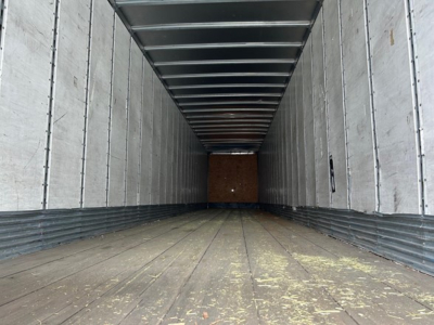 Trailer interior showing empty cargo area with metal walls and ceiling, wooden floor at front, 2014 Stoughton Air Ride Dry Van.