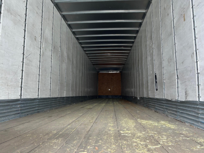 Stoughton 2014 air ride dry van trailer interior showing metal walls, ribbed ceiling beams, and wooden floor with wear marks.