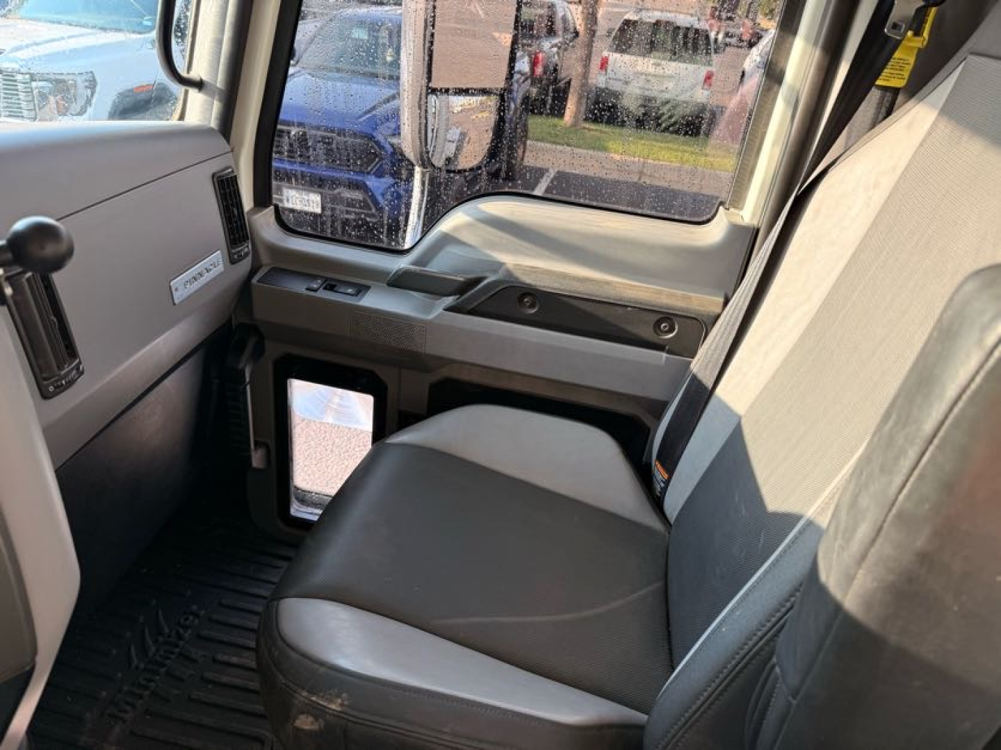 Cab interior of a Mack Pinnacle truck with gray seats and dashboard; visible text includes VIN and stock info on the listing: VIN 1M1PN4GY1LM006714, Stock B3806.