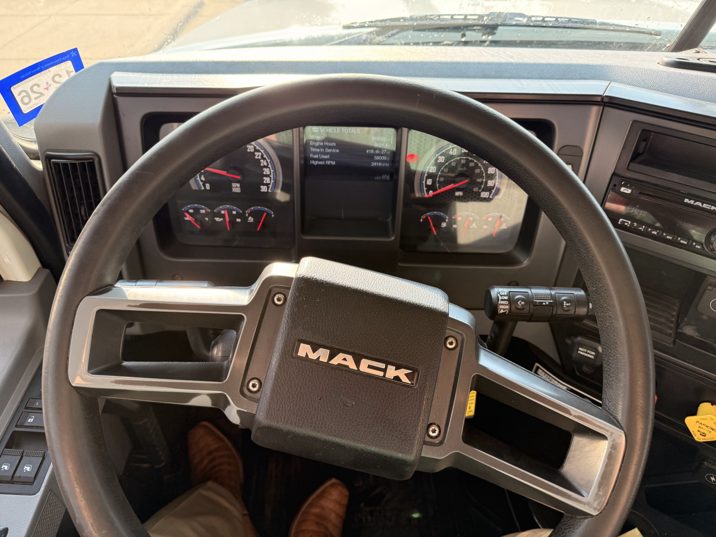 Steering wheel in Mack Pinnacle truck cab with instrument cluster and dashboard controls visible