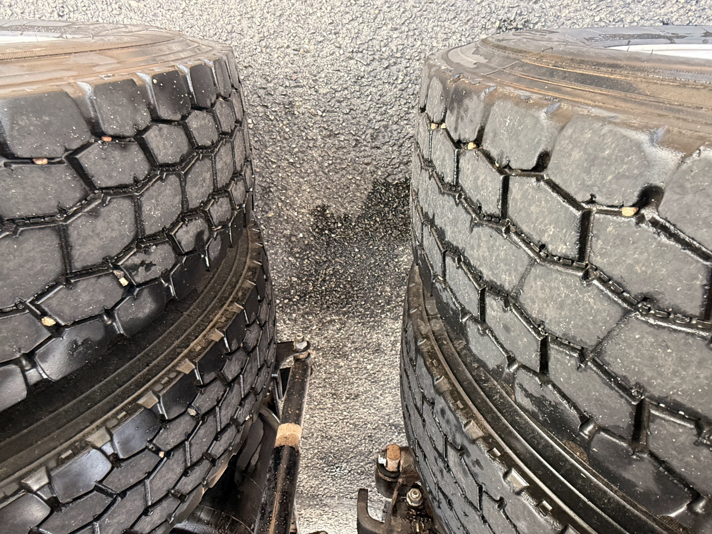 Mack Pinnacle truck tires with tread visible side-by-side in the foreground.