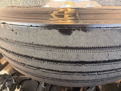 Spare tire mounted on a Mack Pinnacle truck showing tread details and sidewall marks.
