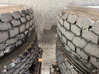 Mack Pinnacle truck tires with tread visible side-by-side in the foreground.