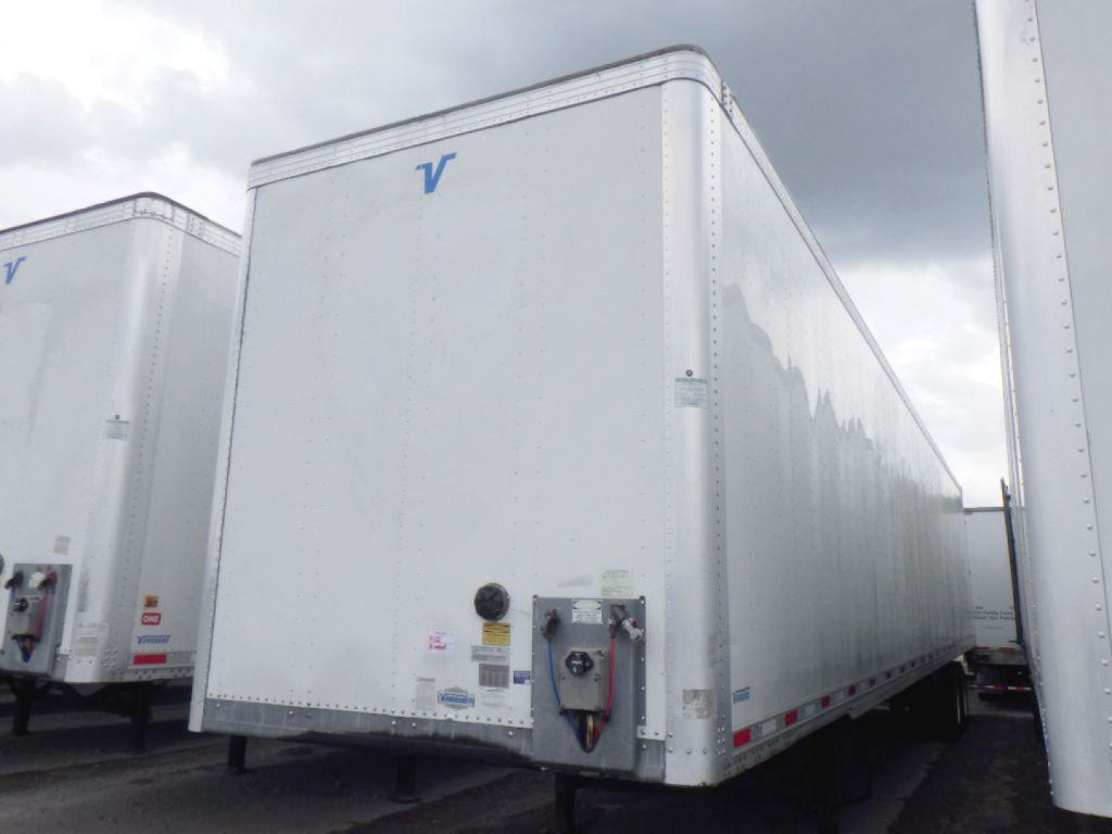 Trailer body showing Vanguard logo and hitch equipment with safety decals visible