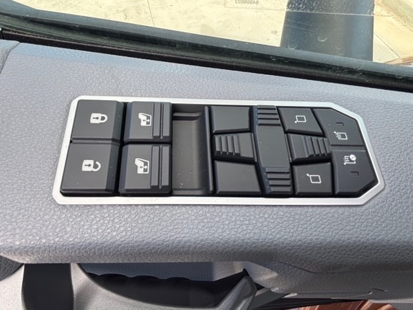 Door control panel in a Mack PR64T76H cab showing window and lock control switches.