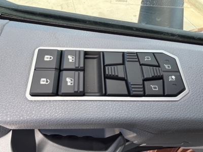 Door control panel in a Mack PR64T76H cab showing window and lock control switches.