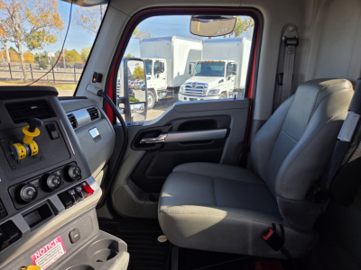 Kenworth T880 cab interior showing driver and passenger seats with dashboard controls.