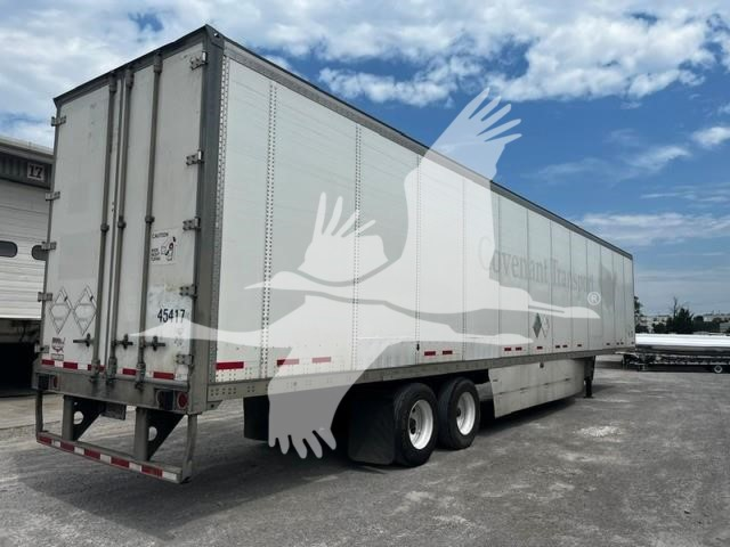 Trailer exterior showing rear and side of a 2017 Wabash van trailer with stock number 7706 and VIN 1JJV532D7HL942038.