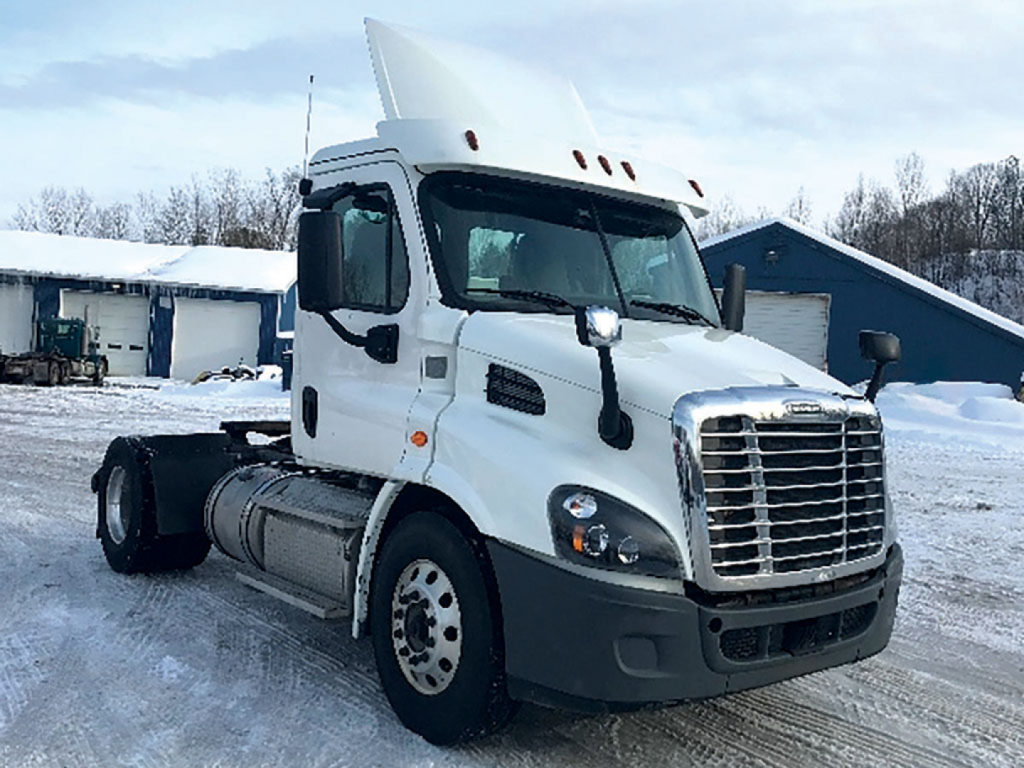 Frieghtliner Cascadia113 semi truck cab front-left view showing headlight cluster and grille