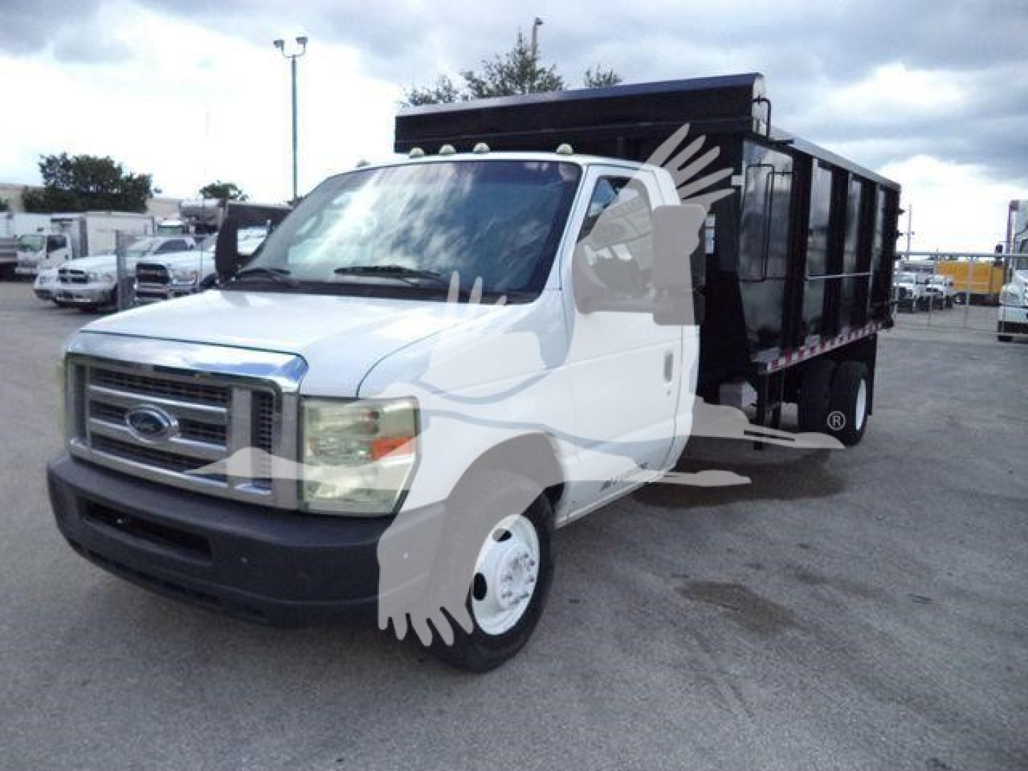 Ford E-450 dump truck in-service with white cab and black dump bed, VIN 1FDXE4FS7BDA10516 visible on listing.