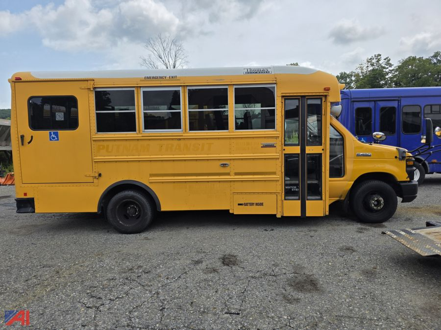 Yellow Ford E-Series school bus side view showing side doors and windows with 'PUTNAM TRANSIT' lettering along the body.
