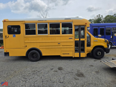Yellow Ford E-Series school bus side view showing side doors and windows with 'PUTNAM TRANSIT' lettering along the body.