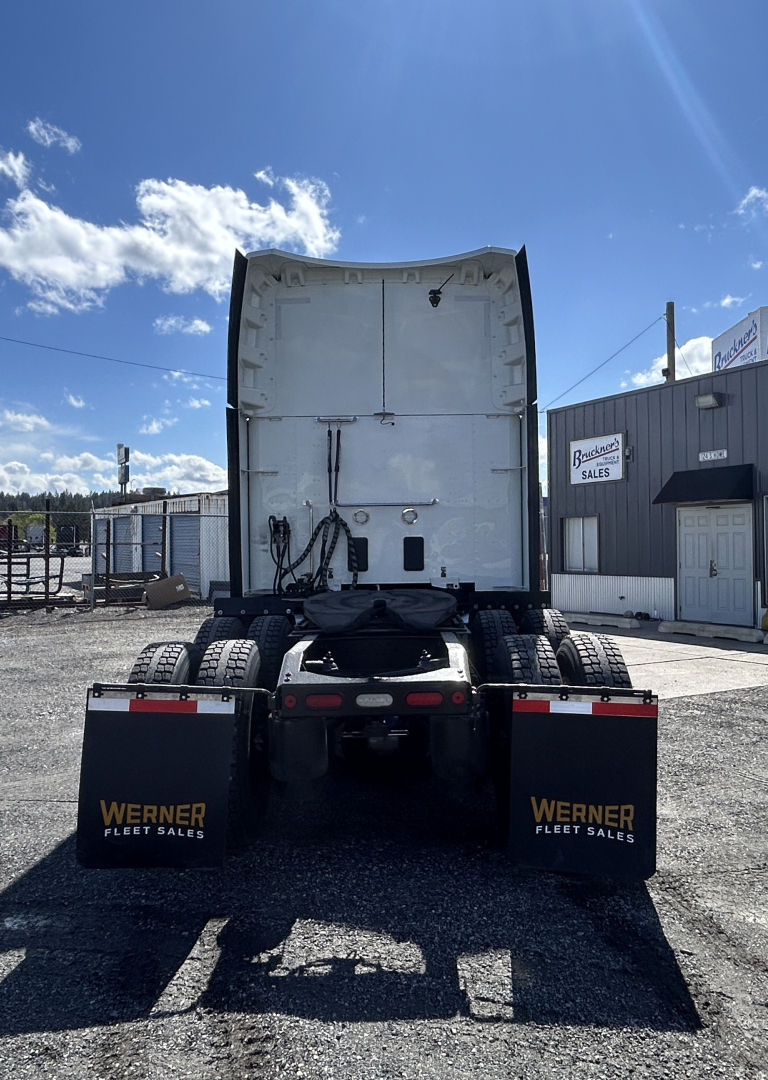 Peterbilt 579 tractor rear view showing dual rear axles, mud flaps with Werner Fleet Sales logos, and fifth wheel area.