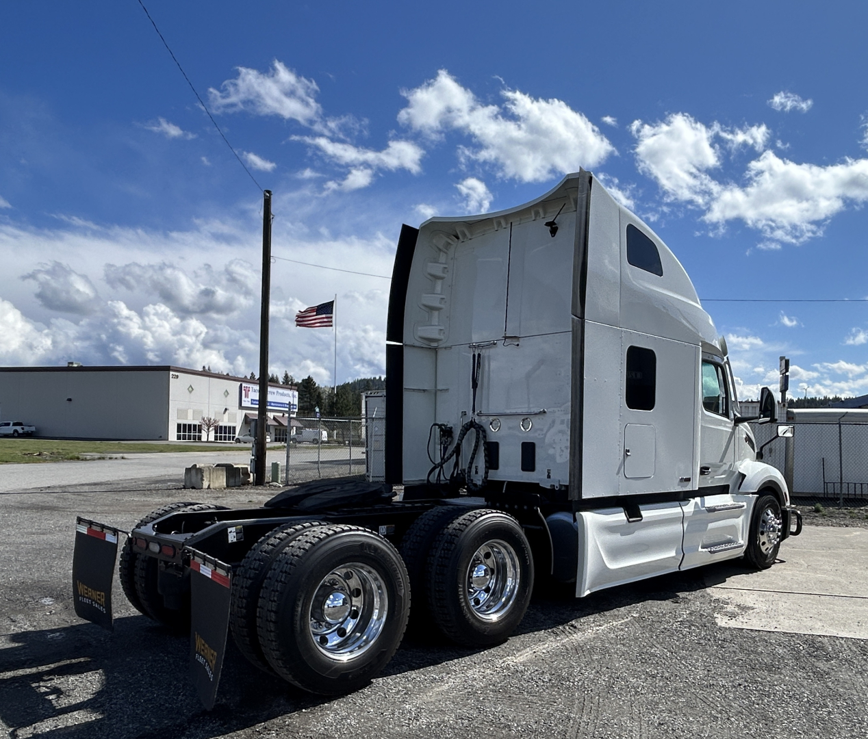 Peterbilt 579 semi truck in-value used condition shown from side/rear, sleeper cab, 6-wheel rear with chrome rims and dual rear axles; no visible text readable