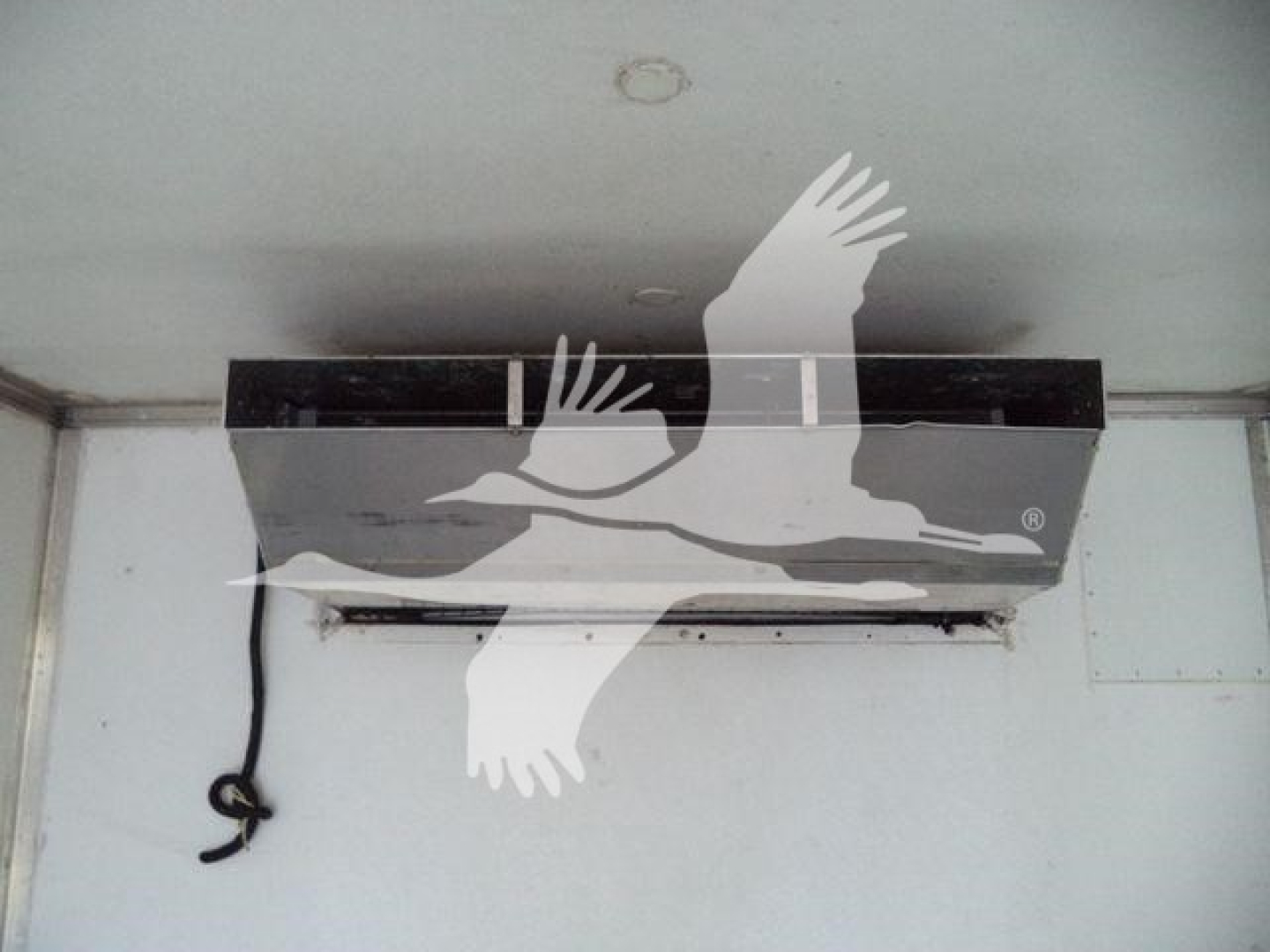 In-vehicle refrigeration unit interior with a black strip and a hanging wire; no visible text legible due to watermark