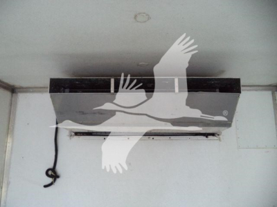 In-vehicle refrigeration unit interior with a black strip and a hanging wire; no visible text legible due to watermark
