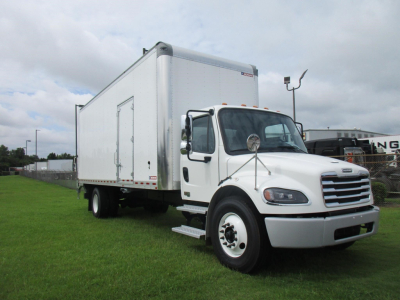 Freightliner M2 106 box truck side view showing cargo box and cab with white exterior.