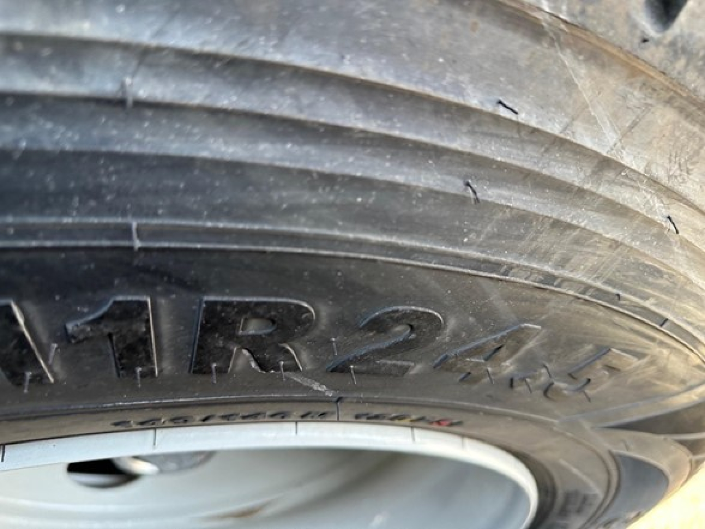 Tire sidewall with embossed letters 'TR24' visible on the tire, part of a Jet Air Ride Side Dump trailer.