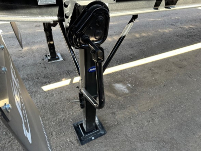 Jet Air Ride Side Dump trailer hitching mechanism and support leg showing hydraulic system and frame detail.