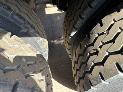 Jet Air Ride Side Dump trailer tires close-up view showing tread patterns and gap between wheels.