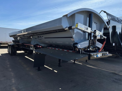 Jet Air Ride Side Dump trailer in a parking lot showing side discharge chute and hydraulic components.