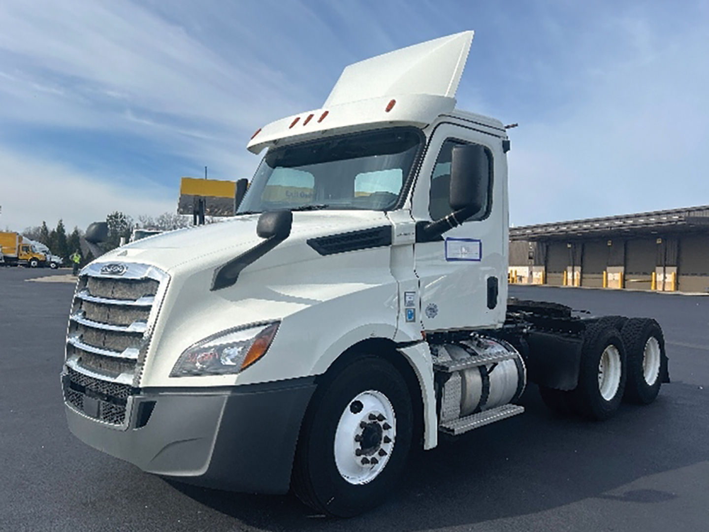 Truck cab of a 2019 Freightliner Cascadia126 head-on view showing front grille, windshield, and side mirrors; white exterior with large hood and sleeper.