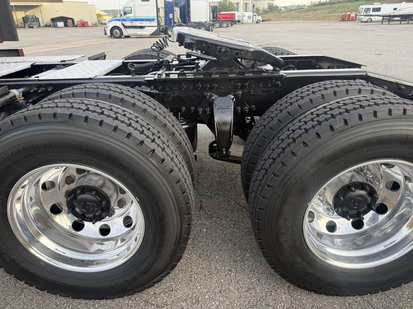 Freightliner Cascadia 126 rear wheel hubs and fifth wheel area with dual rear axles and chrome rims.