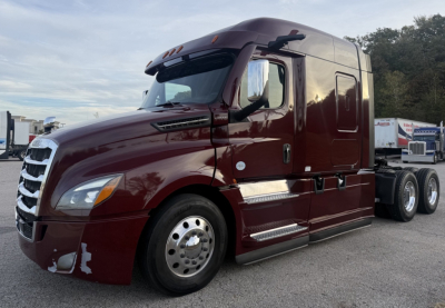 Freightliner Cascadia 126 semi-truck in maroon color, side view showing sleeper cab and dual rear axles.